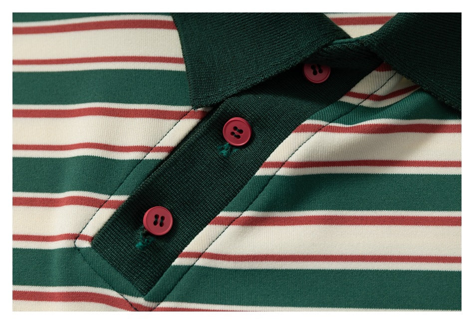 Close-up of the dark green polo placket with three red buttons against green, cream, and muted red stripes.