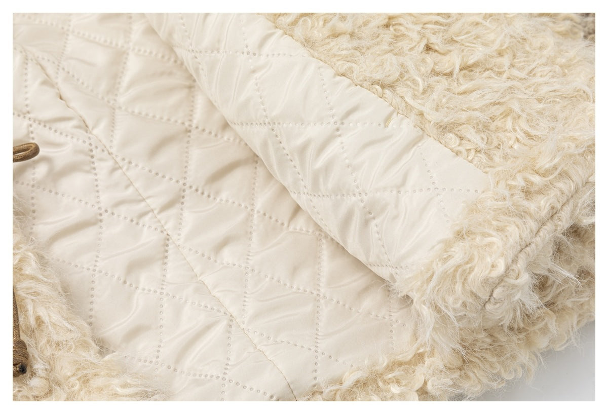 Close-up showing cream quilted lining beside the garment's fluffy outer surface.
