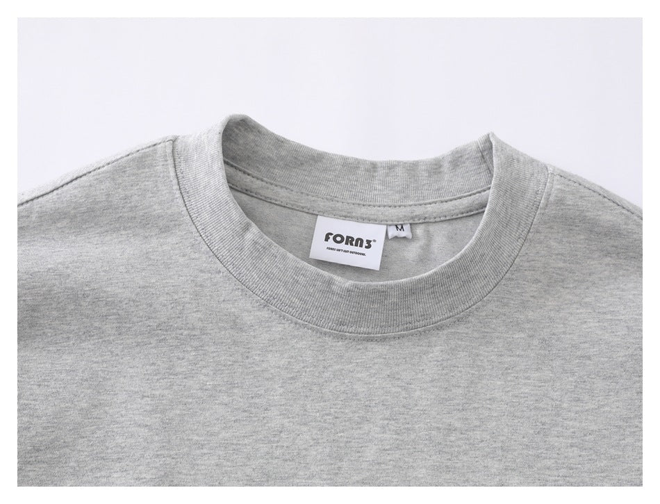 Close-up of a heather gray T-shirt neckline with a visible FOROS neck label and size tag.