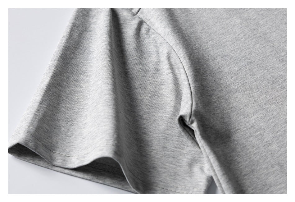 Close-up of a heather gray T-shirt sleeve and underarm seam.