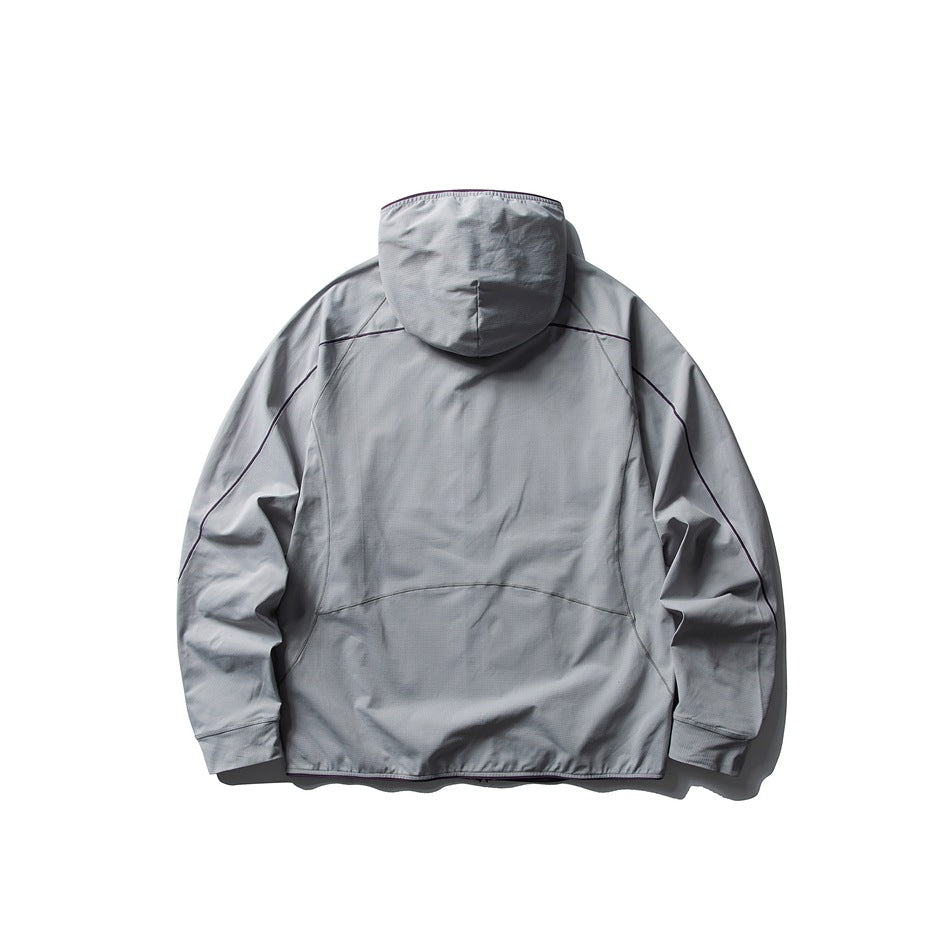 Back view of a light gray hooded jacket with dark seam detailing and long sleeves, laid flat on white.