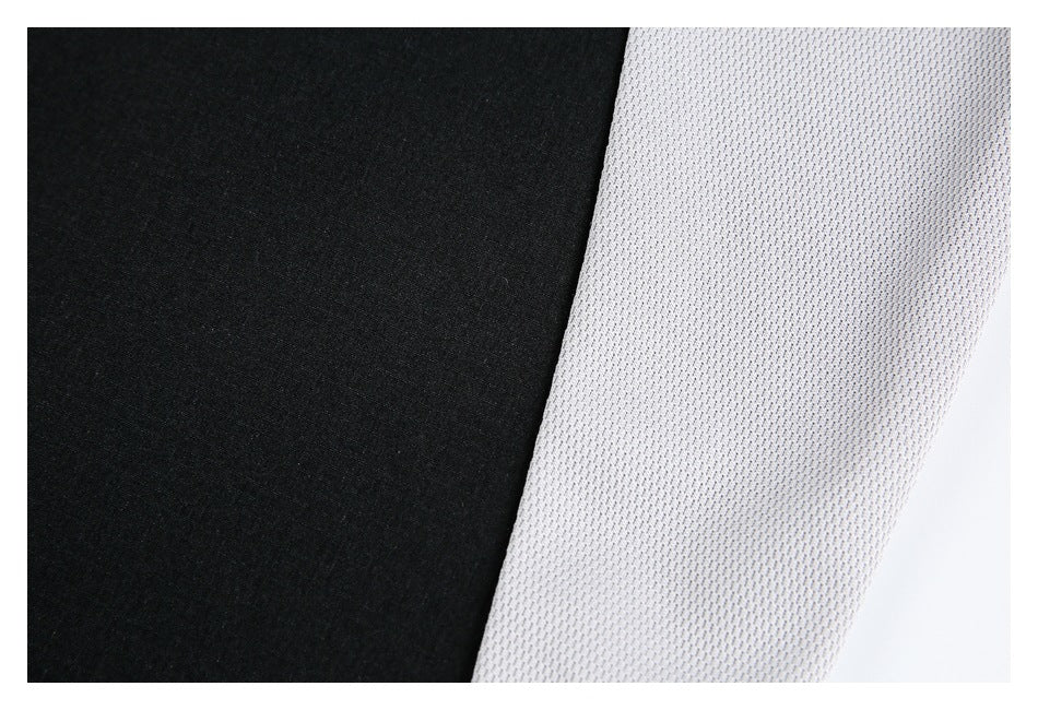Close-up of a black shirt panel beside a light gray textured panel.