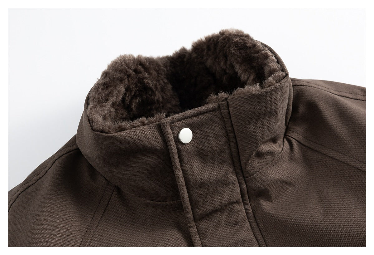 Close-up of a brown jacket's high collar, plush lining, and snap-button front tab.