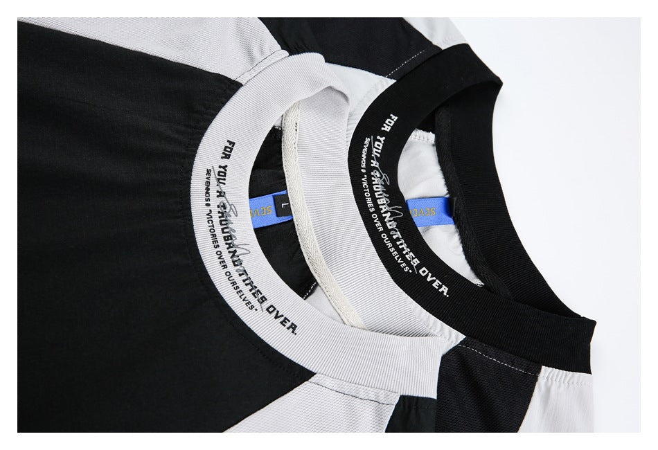 Overlapping close-up of black and light gray color-block shirt necklines with contrasting ribbed collars and printed text.
