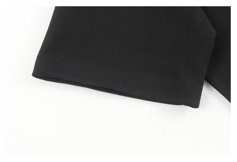 Close-up of the double-stitched hem on a black garment.