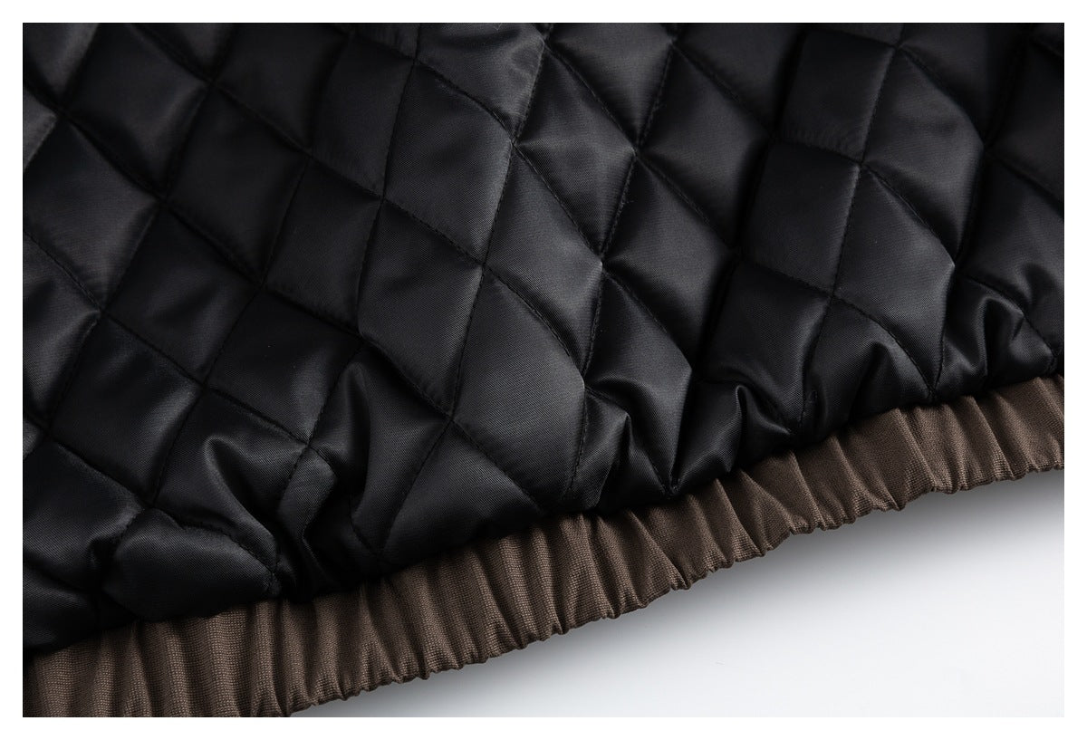 Close-up of black diamond quilting above a gathered brown fabric edge.