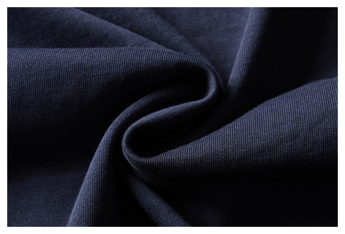 Close-up of dark navy knit fabric gathered into soft folds, showing its fine ribbed texture.