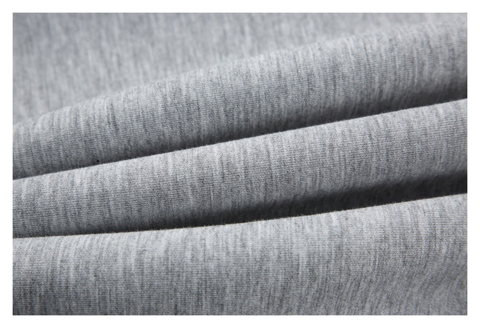 Macro close-up of gray heather sweatshirt fabric folded into soft ridges.