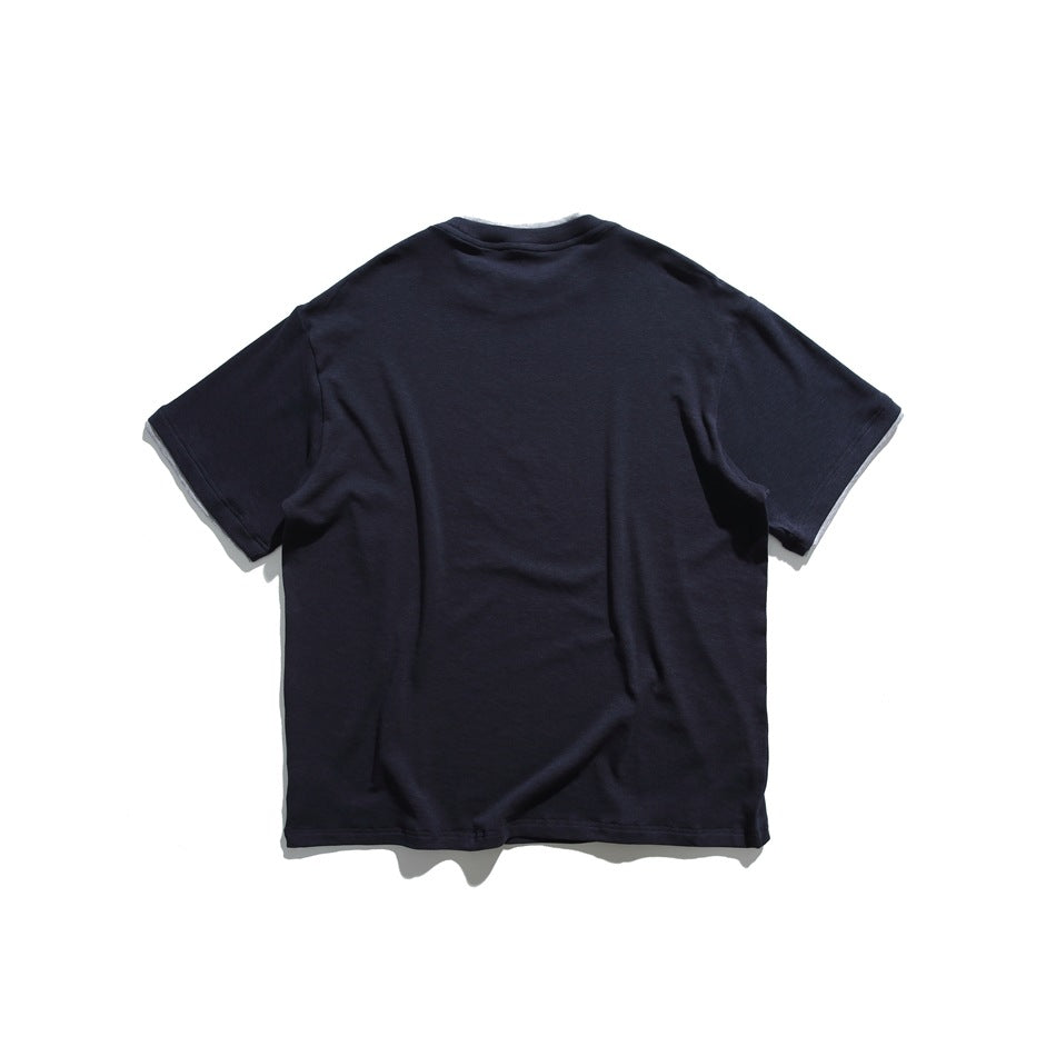 Back view of a plain dark navy short-sleeve crew-neck T-shirt with light gray fabric visible at the sleeve edges.