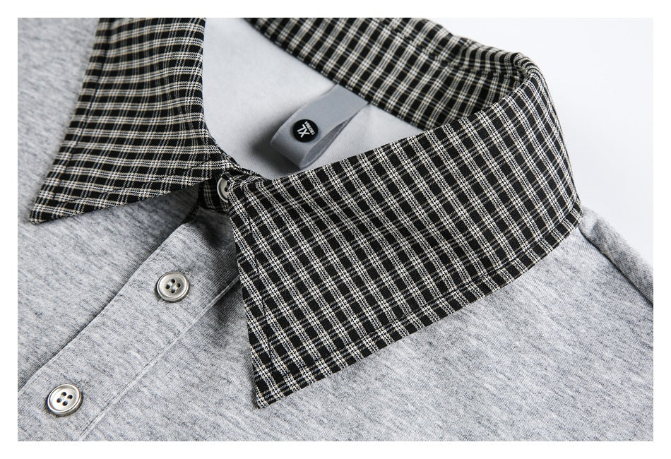 Close-up of the black-and-white checked collar on a gray top.
