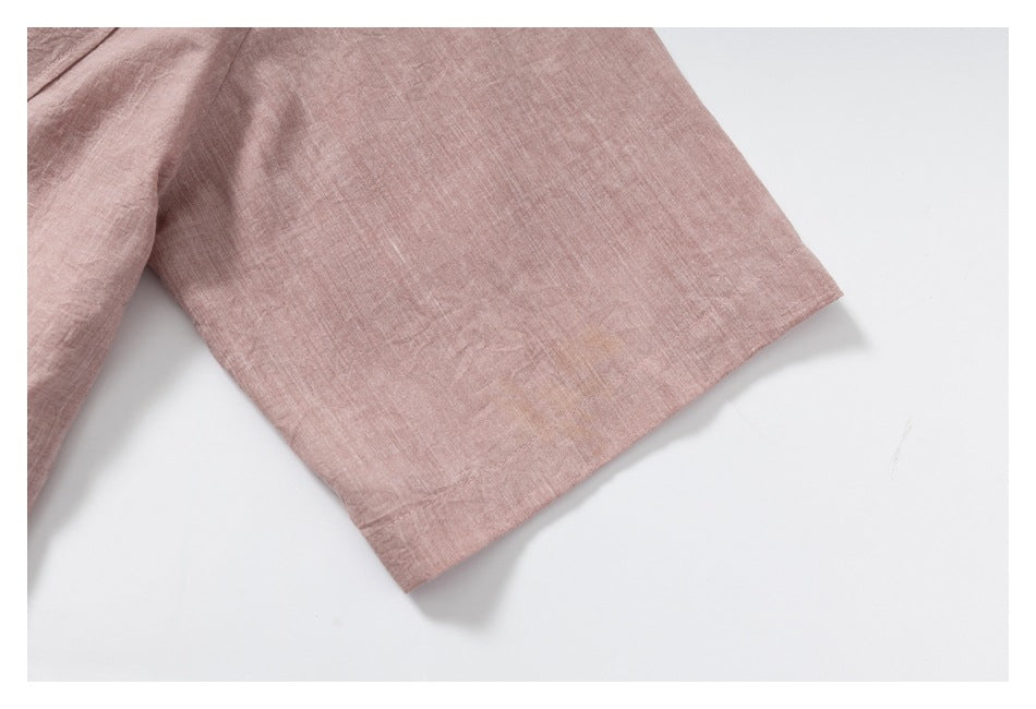 Close-up of a short sleeve and stitched hem on a dusty rose garment.
