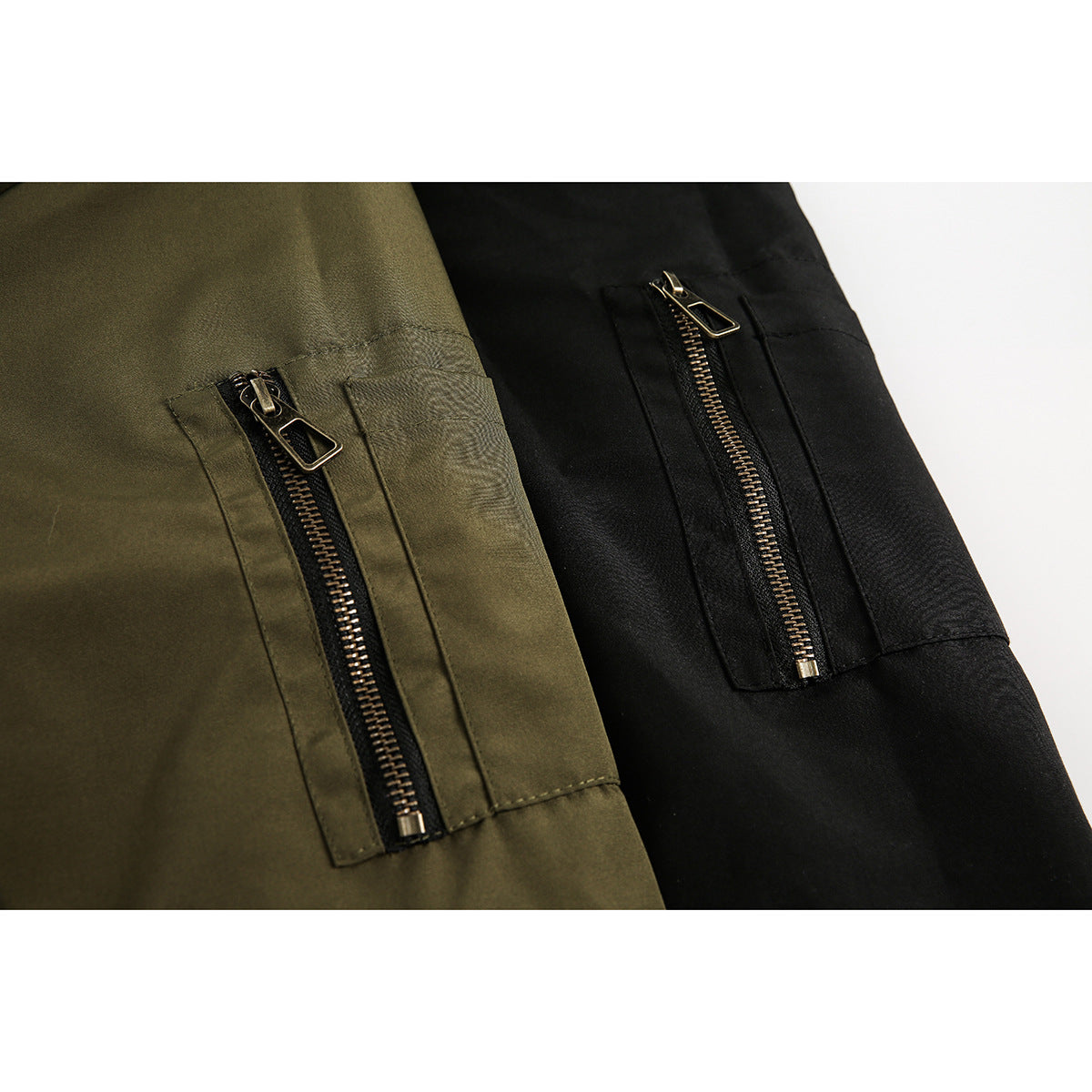 Close-up of vertical zip pockets on olive and black bomber jackets.