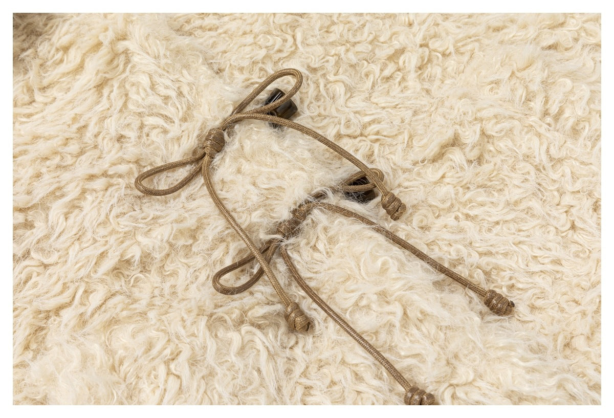 Brown cord toggles and loops shown against curly cream-colored pile fabric.