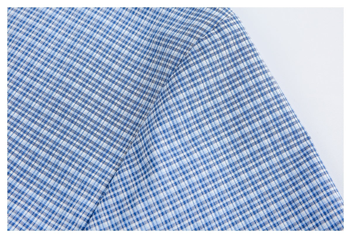 Close-up of a blue-and-white checked garment showing a curved shoulder or sleeve seam.