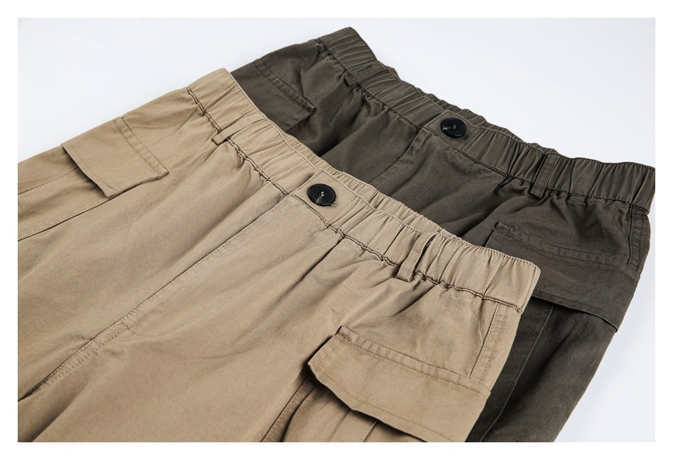 Khaki and dark olive cargo pants overlap, showing elastic waistbands, buttons and flap pockets.