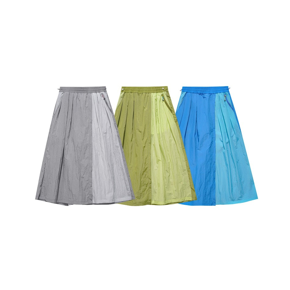 Three pairs of wide-leg pants in gray, light olive, and bright blue, shown together from the front.