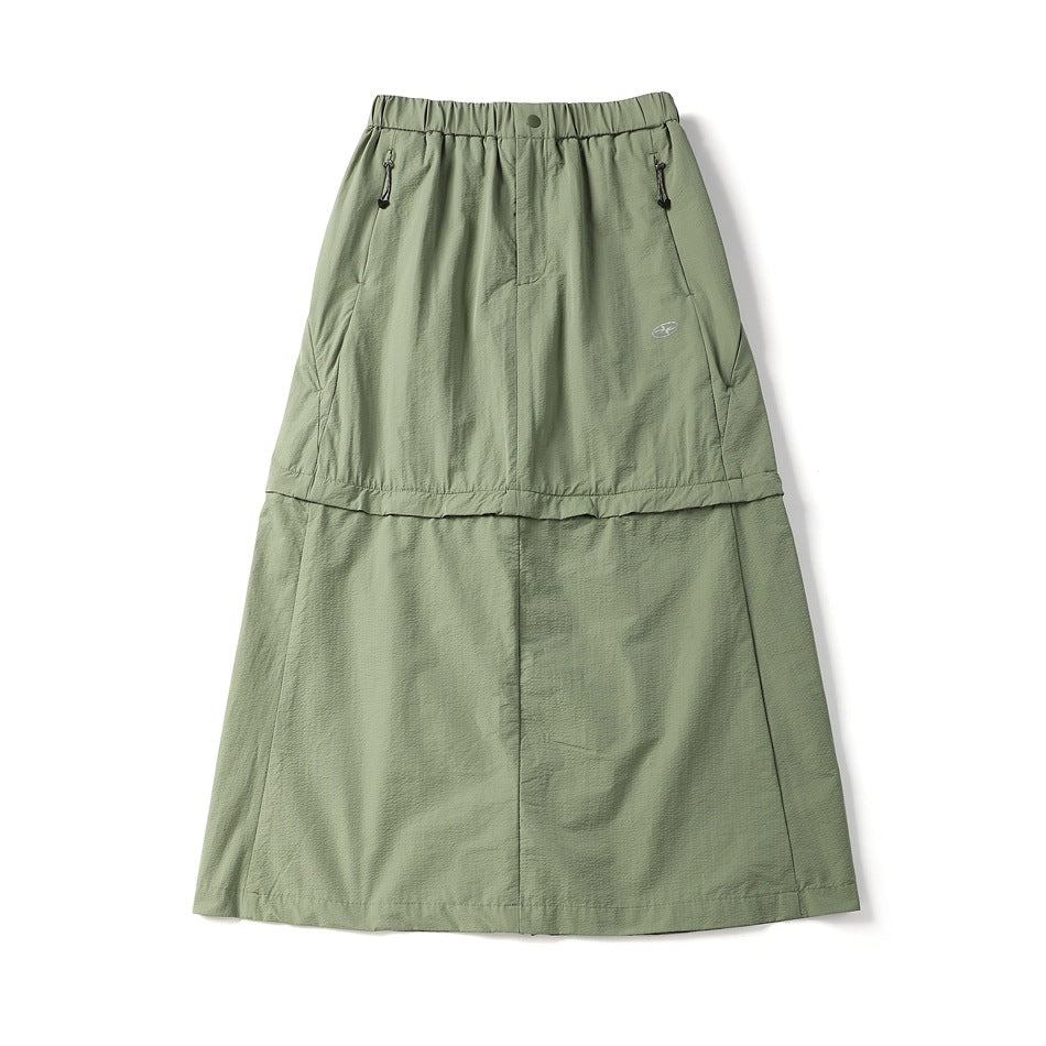 Green midi skirt flat lay with elastic waist, snap button, side zip pockets and a two-tier seam