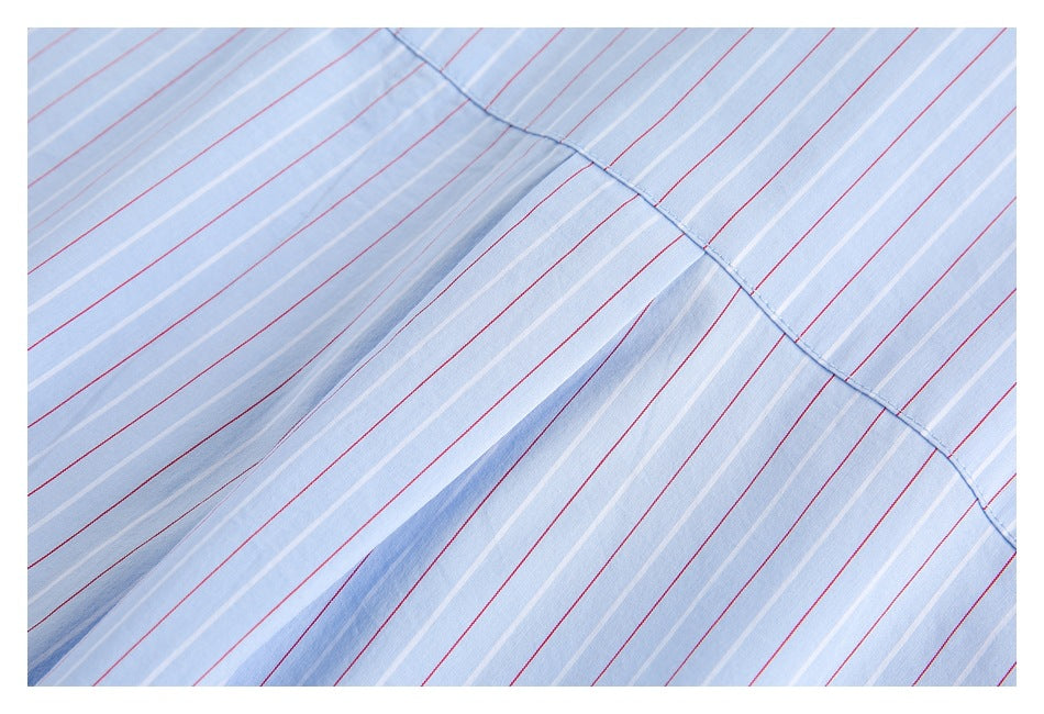 Close-up of the shirt's back yoke seam and pleat on light blue fabric with red and white stripes.