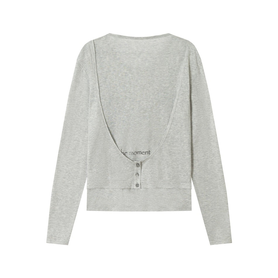 Heathered gray long-sleeve top, back view, with deep scooped outer layer, three buttons and small 'the moment' print