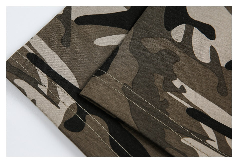 Close-up of overlapping camouflage garment panels with visible stitching.