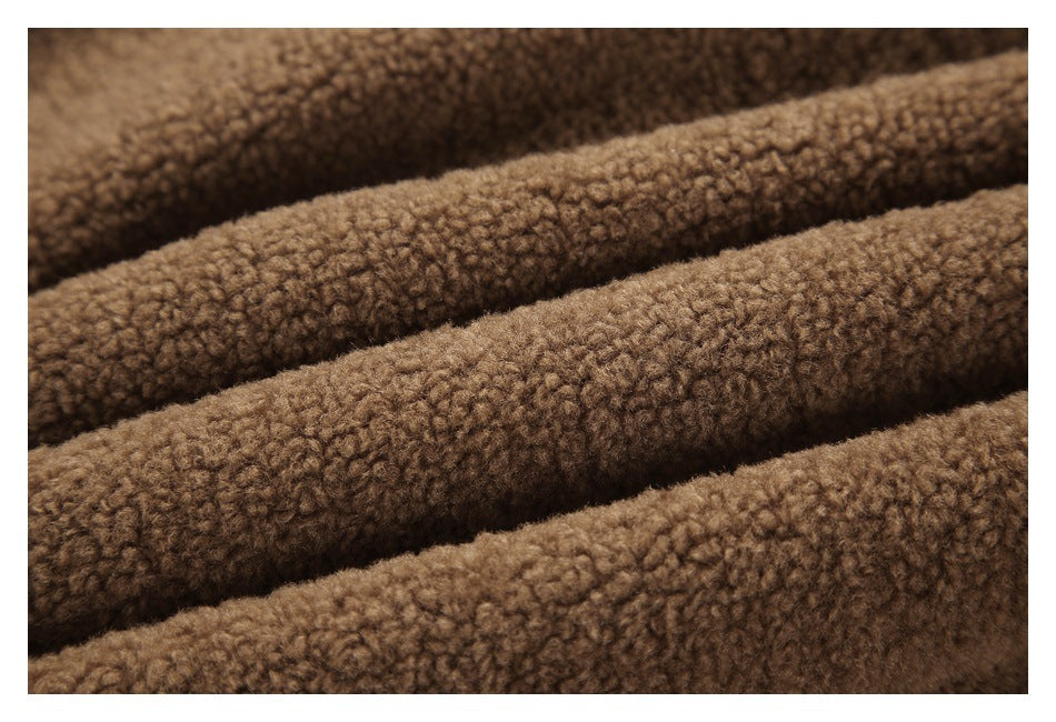 Macro view of brown curly-textured fabric arranged in soft folds.