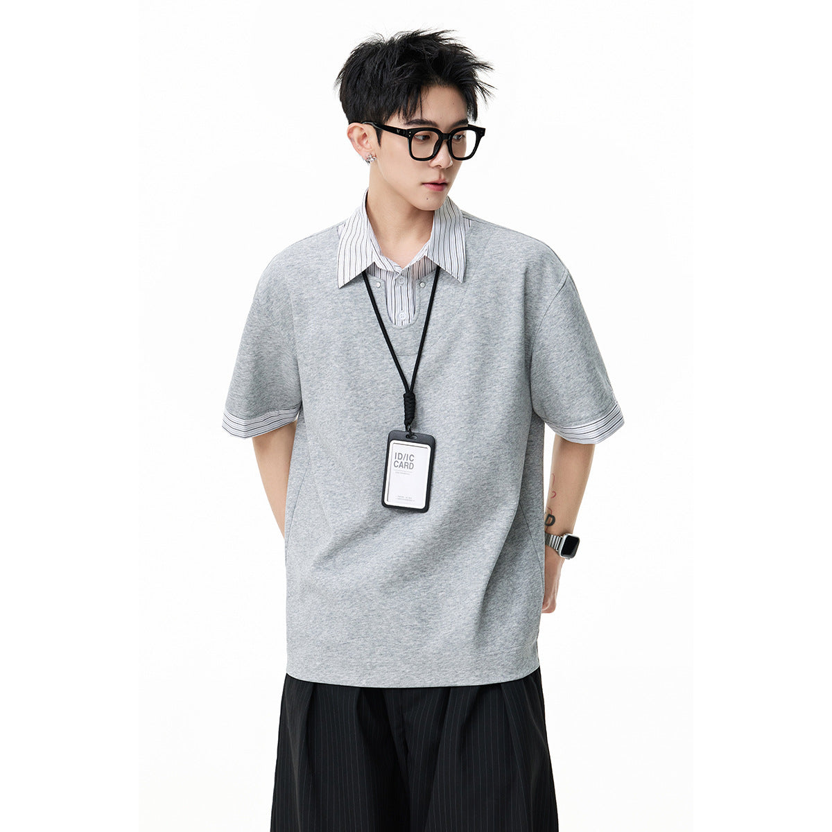 Model wearing a light gray oversized short-sleeve top with a white pinstriped collar and matching sleeve cuffs.
