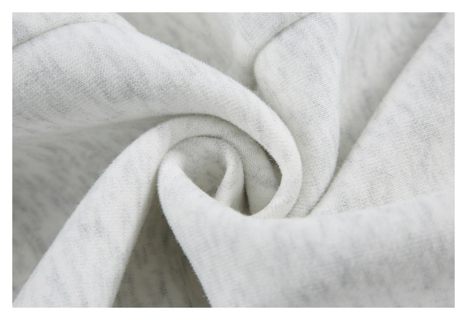 Close-up of light gray marled fabric gathered into a spiral fold.