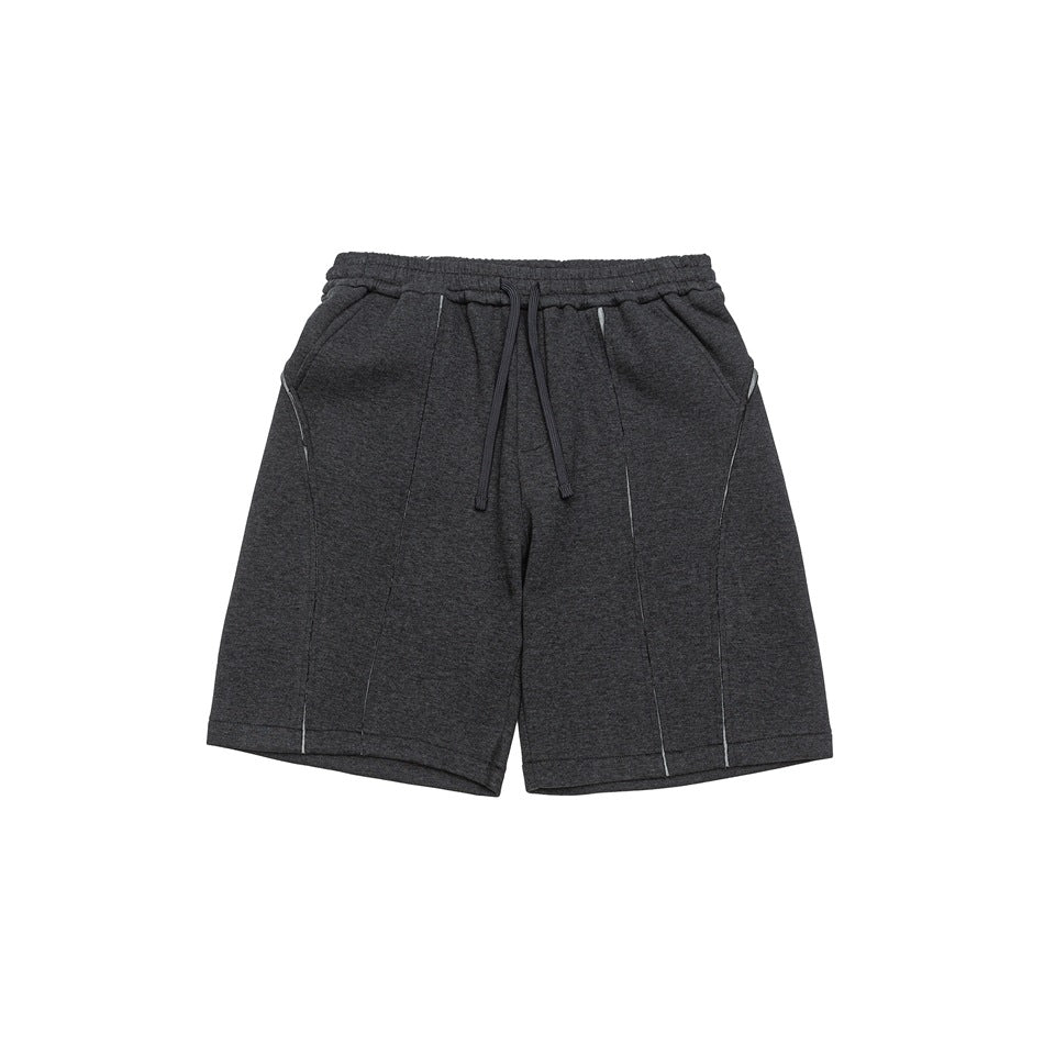 Dark gray heathered drawstring shorts with elastic waist, side pockets and contrast seam details, flat front view