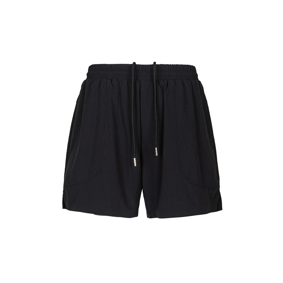 Black drawstring athletic shorts with elastic waistband, front panel seams and side hem slits, flat lay front view