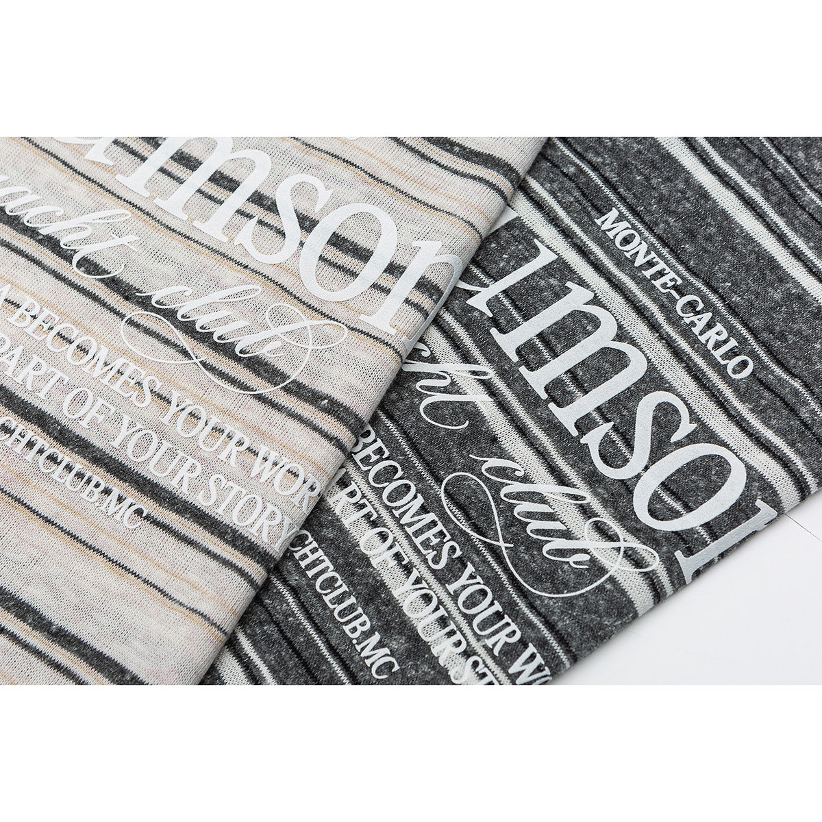 Close-up of cream and charcoal striped shirts with large white English text printed on the fabric.