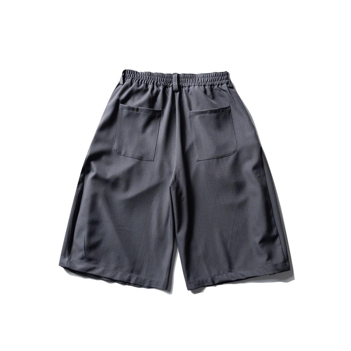 Back view of charcoal gray wide-leg shorts with an elastic waistband and two patch pockets.
