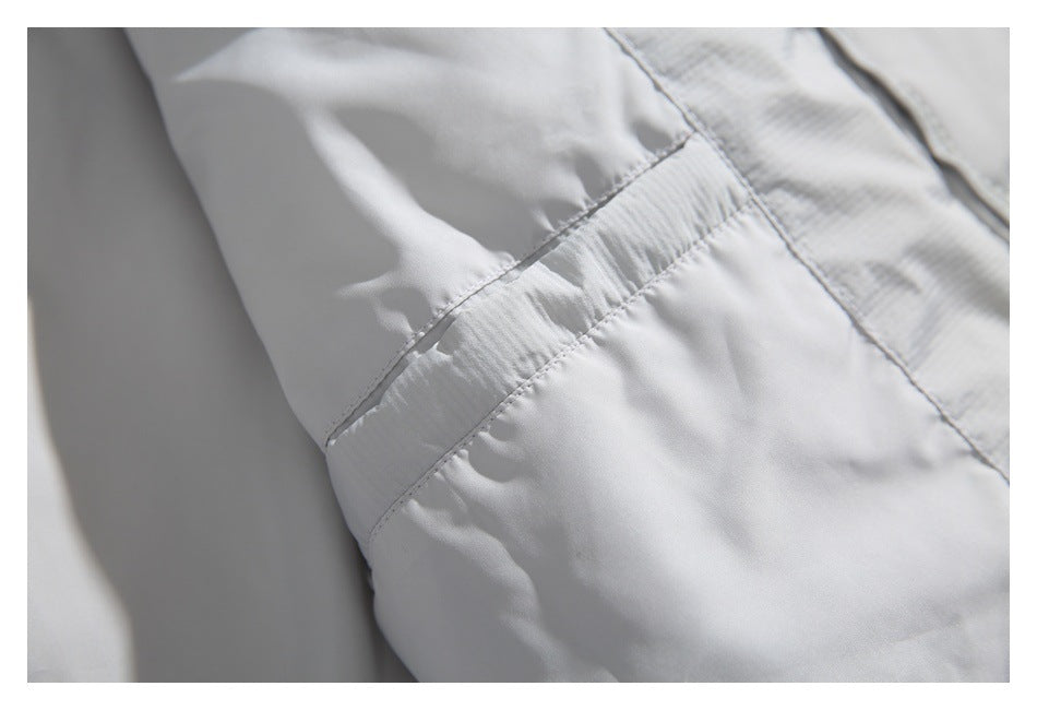 Close-up of a stitched seam joining smooth white lining to the quilted outer fabric.