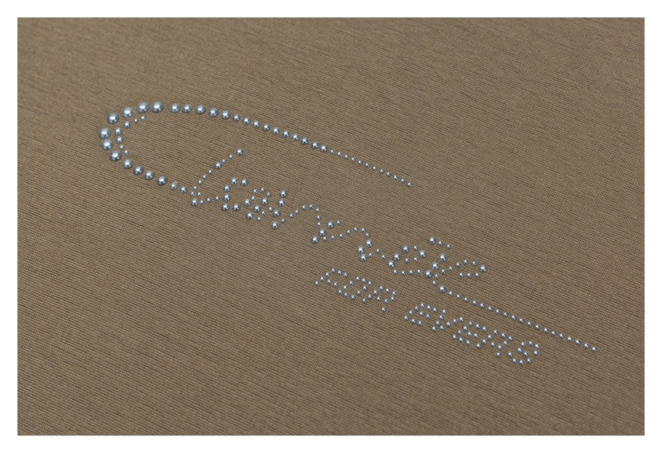 Silver rhinestone lettering and a curved decorative motif on taupe fabric.