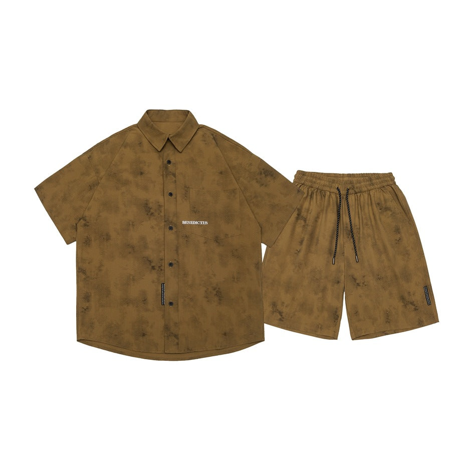 Flat lay of a brown mottled short-sleeve button-up shirt with matching drawstring shorts.