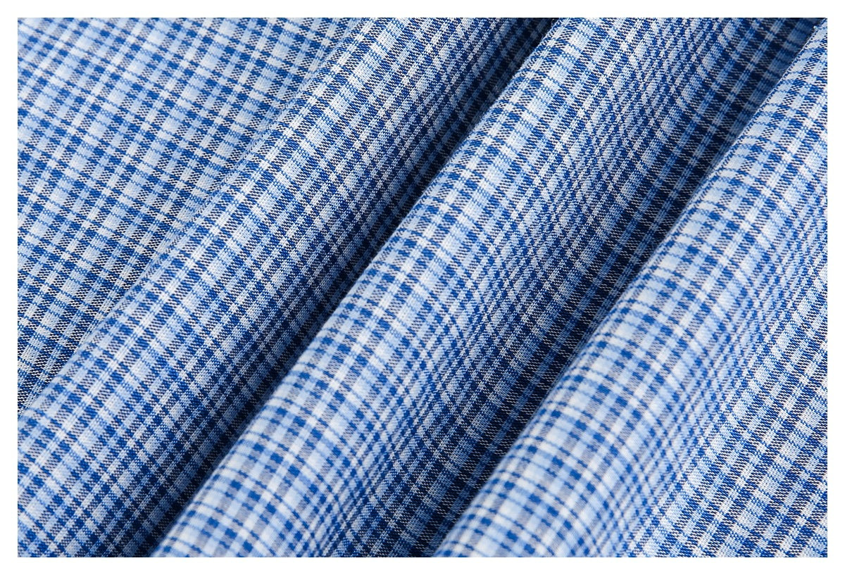 Close-up of blue-and-white checked fabric arranged in soft folds, showing its woven pattern.