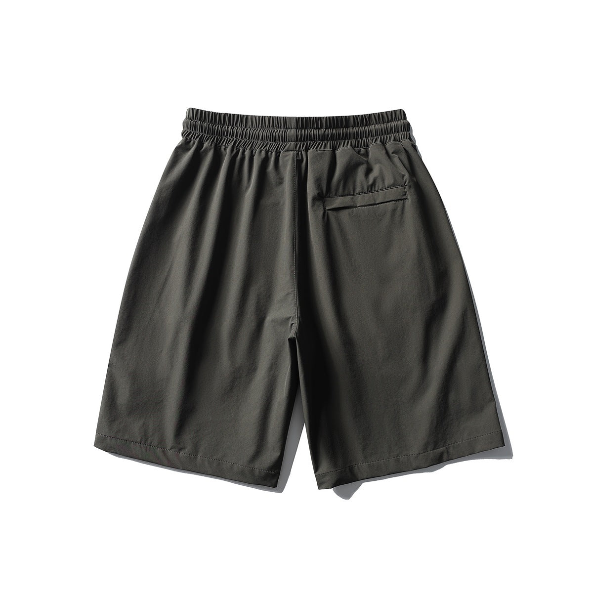 Back view of dark gray shorts with elastic waistband and a single welt pocket