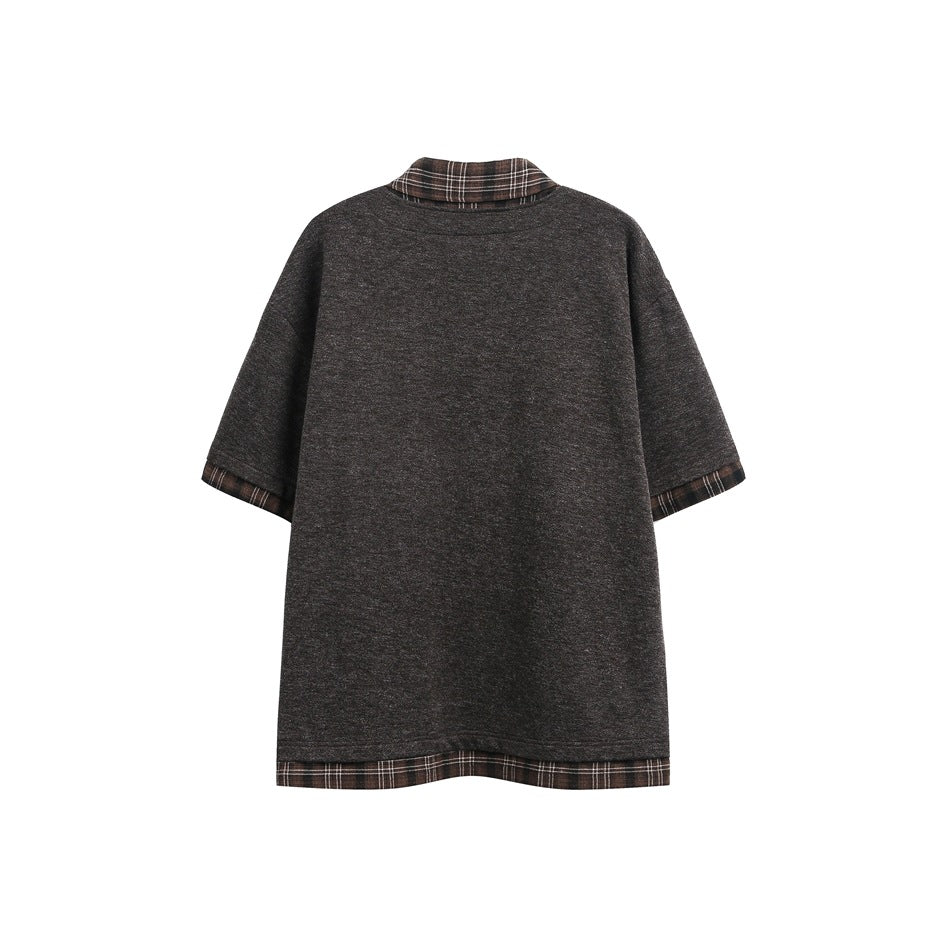 Back of a charcoal heather short-sleeve collared shirt with brown plaid trim at the collar, cuffs, and hem.