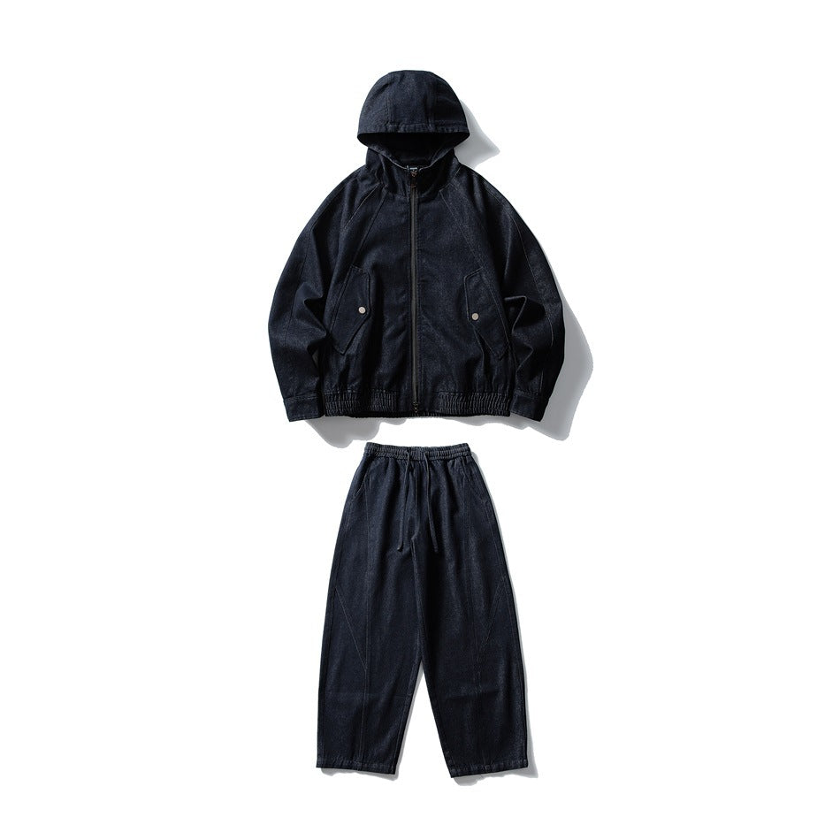 Flat lay of a dark indigo hooded zip jacket with flap pockets and matching drawstring pants.
