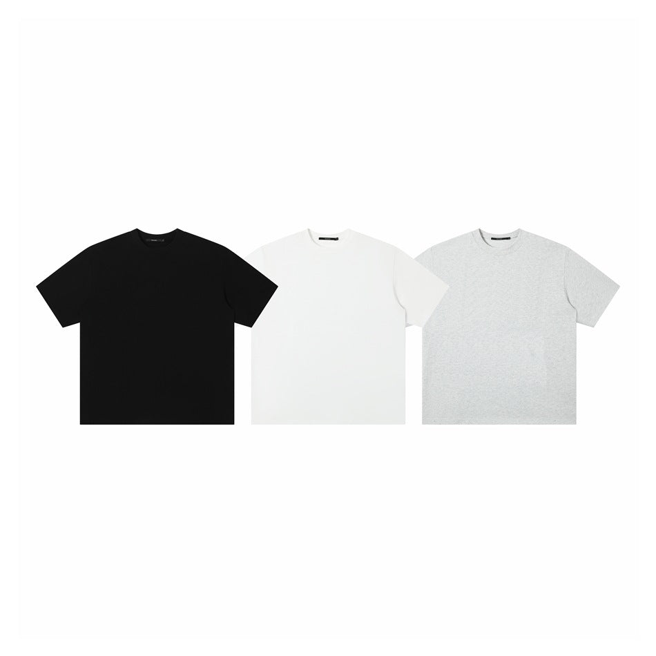 Three plain crew-neck T-shirts shown from the front in black, white, and heather gray.