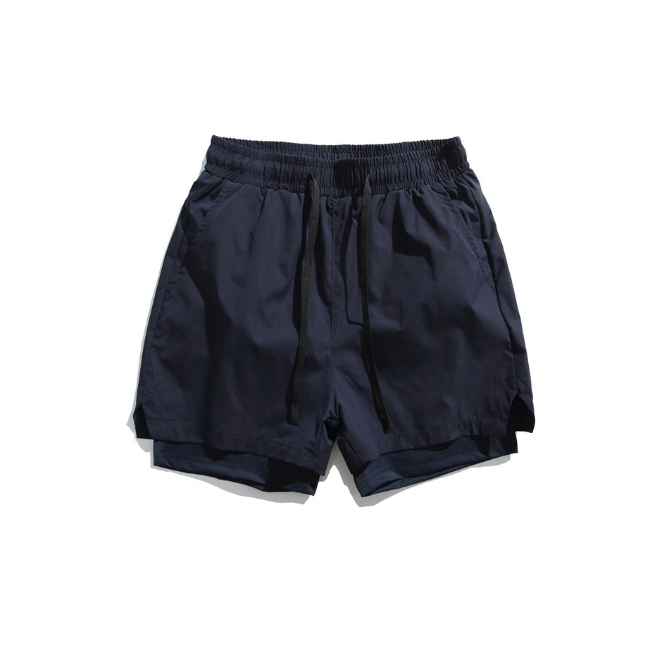Navy drawstring shorts flat lay, front view, with elastic waistband, side pockets and layered hem
