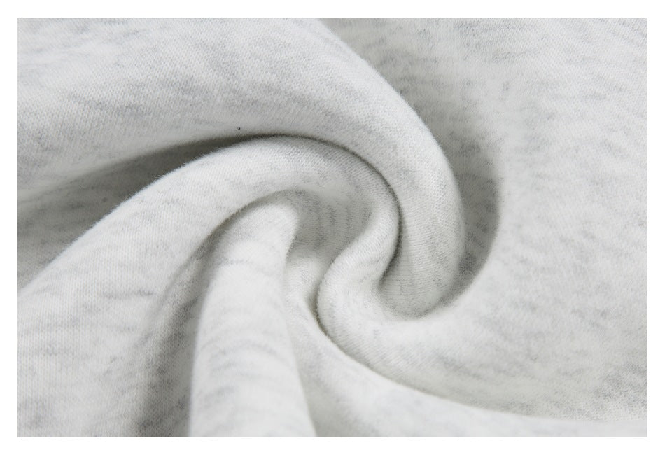 Close-up of soft-looking, light gray heathered fabric gathered into folds.