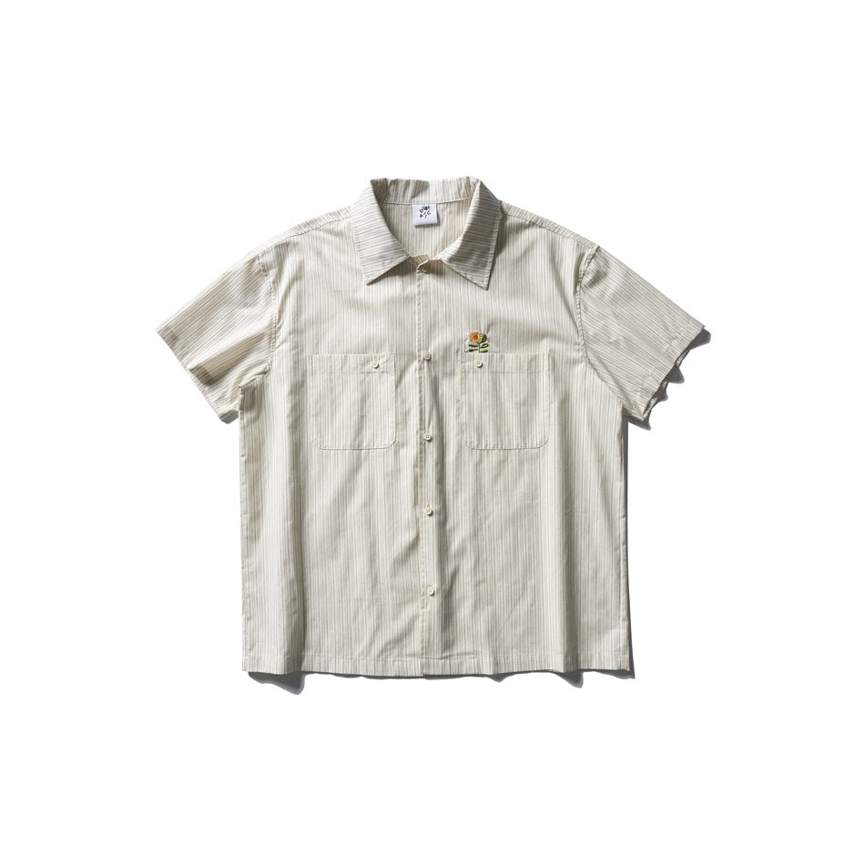 Apricot striped short-sleeve button-up shirt with two chest pockets and a small embroidered sunflower, flat lay