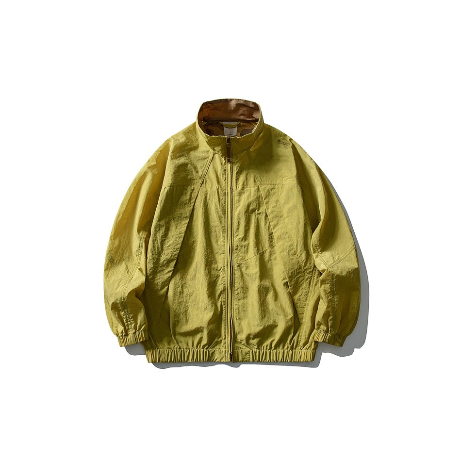 Moss yellow zip-up stand-collar jacket with textured crinkled fabric and elastic hem