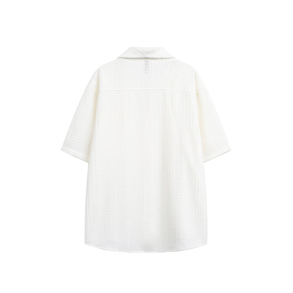 Back view of a white short-sleeve collared tunic with vertical openwork texture, shown flat against a white background.