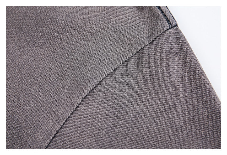 Close-up of the gray T-shirt's shoulder seam and sleeve.
