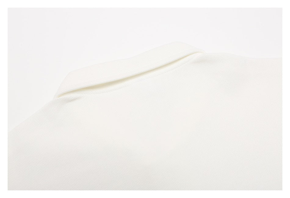 Close-up of white textured fabric with a folded edge.
