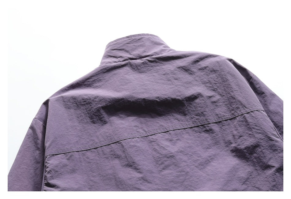 Cropped back view of a purple jacket showing its collar and horizontal back yoke seam.