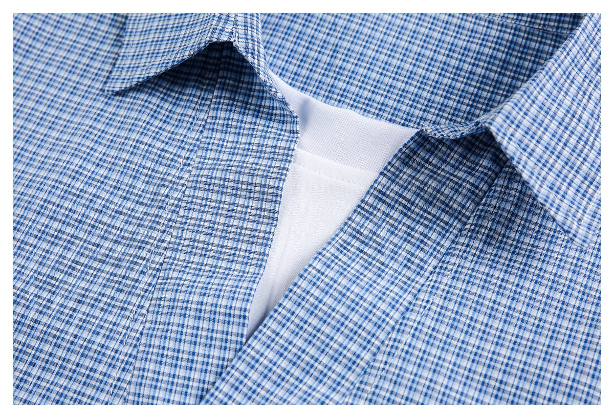Close-up of the checked shirt's open neckline, collar, and front opening over a white undershirt.