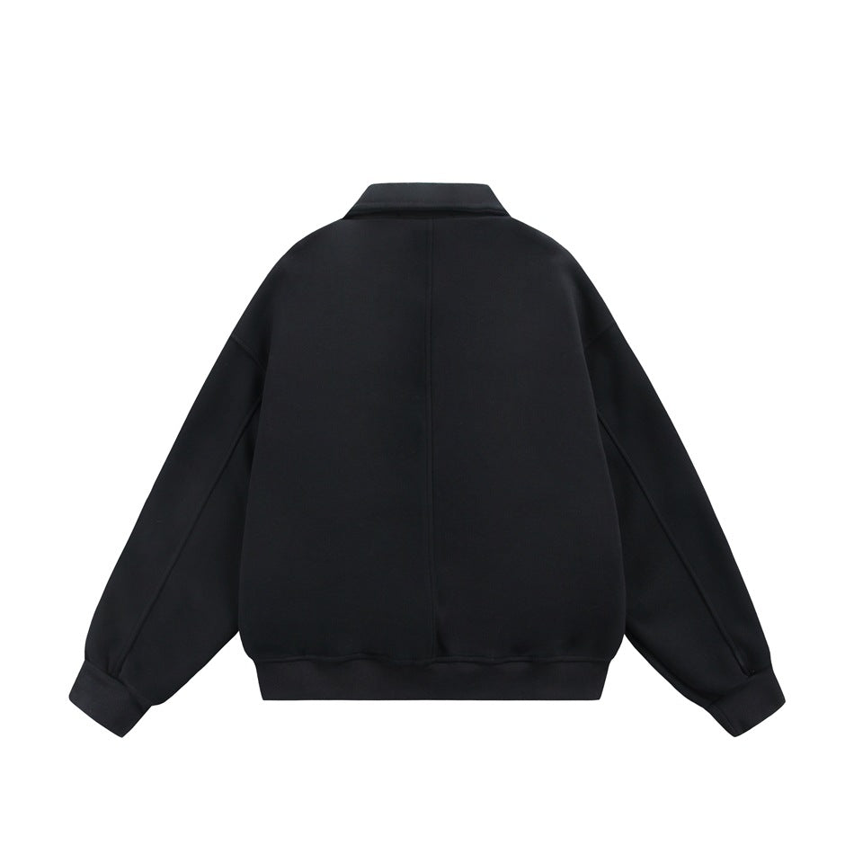 Back view of a black jacket with a pointed collar, center seam, and ribbed cuffs and hem.