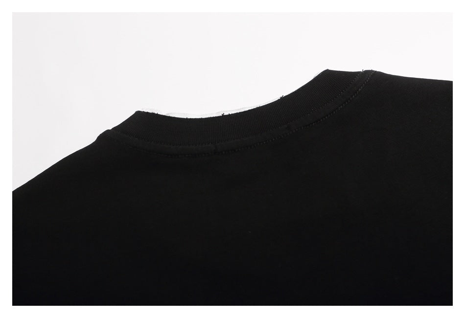 Close-up of the black garment's crew neckline and stitched collar seam.